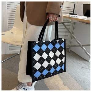 Detail of argyle pattern tote bag with braided rope handles and large capacity
