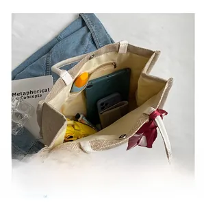 Top view showing spacious interior with pockets and daily essentials in linen tote bag