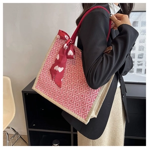 Linen tote bag with red geometric pattern and heart silk scarf shown on model