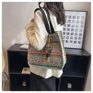 Detail of ethnic geometric canvas tote bag featuring a cute plush bunny charm