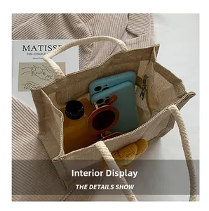 Top view of beige canvas tote bag showing interior space with phone and sunglasses