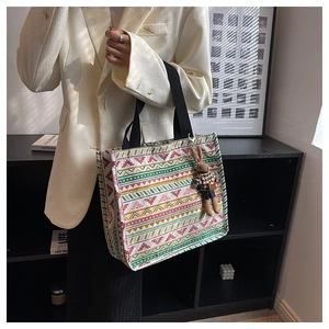 Ethnic canvas tote bag with colorful geometric patterns and a cute rabbit pendant