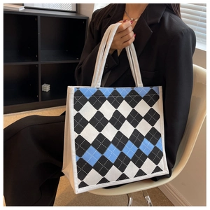 Detail of classic argyle pattern canvas tote bag with sturdy woven white handles