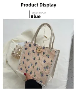 Close-up of floral lace lunch tote bag with rope handle and decorative wood button