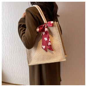Detail of linen tote bag with heart pattern ribbon and sturdy woven rope handles