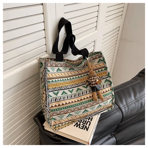 Detailed close-up of geometric pattern canvas tote bag with a cute rabbit charm