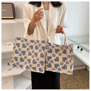 Comparison of two beige canvas tote bags with blue floral and heart patterns for daily use