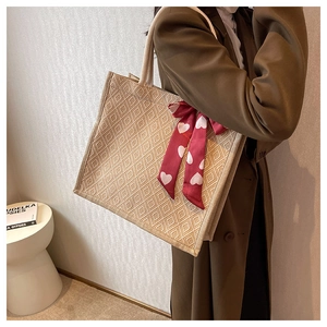 Detail of large linen tote bag with diamond weave and heart print silk scarf