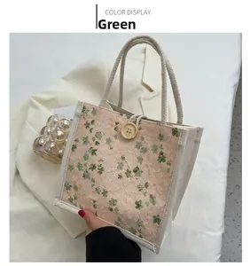 Detail of floral lace mini tote bag with rope handles and round wooden button closure