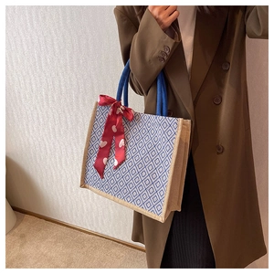 Linen tote bag with blue geometric patterns and heart scarf on rope handles