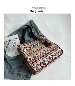 Detail of burgundy ethnic canvas tote bag with geometric patterns and a bunny charm