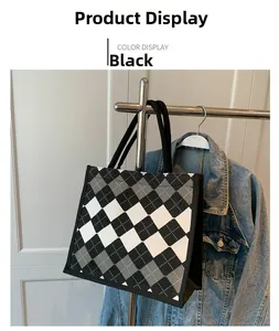 Detail of canvas tote bag featuring black and white checkered pattern and sturdy straps