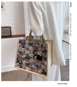 Detailed back view of a large linen tote bag with woven bear pattern and rabbit pendant