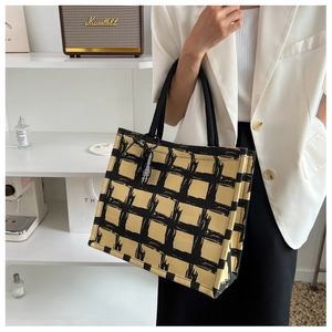 Detail of a large capacity canvas tote bag with black and yellow checkered pattern