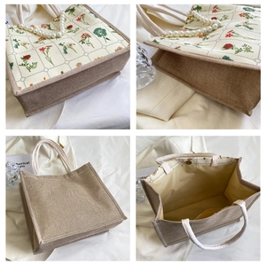 Detail of large canvas tote bag with pearl handle, floral print, and magnetic closure
