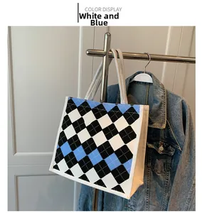 Detail of blue and white argyle knit tote bag with thick cotton rope handles