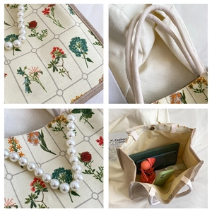 Detail of vintage floral canvas tote bag with pearl chain handle and spacious interior