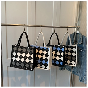 Detailed view of canvas tote bags with quilted patterns in four different colorways
