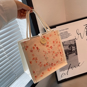 Elegant white lace tote lunch bag with orange floral patterns and cotton rope handle