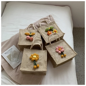 Detailed set of four jute mini tote bags with handmade crochet floral and cherry decors