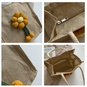 Detailed macro view of woven flax texture and yellow 3D floral accent on a tote bag