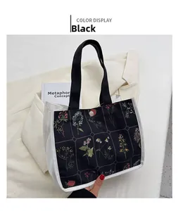 Floral canvas tote bag with magnetic closure placed next to elegant clothing and books