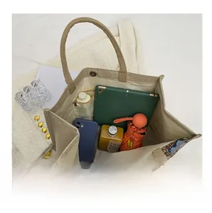 Spacious interior of jute tote bag showing storage for tablet, phone, and umbrella