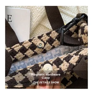 Detail shot of the houndstooth fabric texture and hidden magnetic clasp on the bag