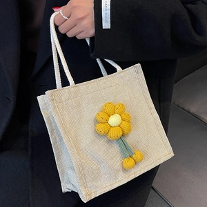 Linen bento tote bag with yellow 3D flower and white rope handles for casual styling
