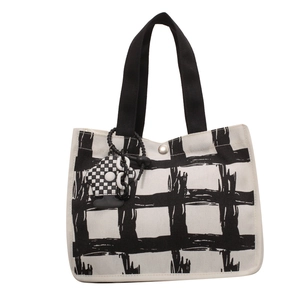 Minimalist black and white checkered canvas tote bag with black handle and silver snap button