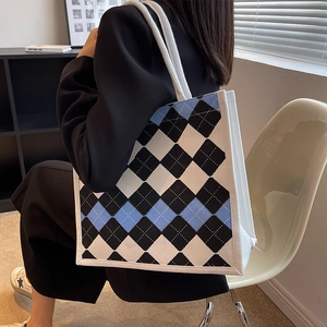 Minimalist argyle canvas tote bag with thick cotton rope handles shown on shoulder