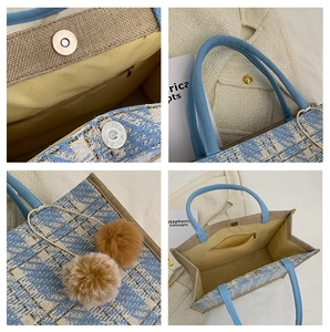 Detail view of large tote bag with geometric pattern, magnetic buckle and plush charms