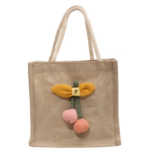 Cute jute lunch bag with knitted cherry charm and thick rope handle in natural beige