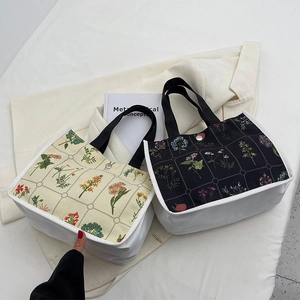 Minimalist canvas tote bag with floral patterns and mesh detail for daily commuting
