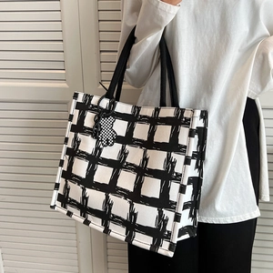 Large black and white plaid canvas tote bag with woven handles and cute bear charm