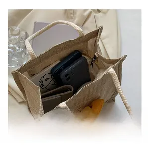 Linen lunch bag interior showing storage space for two smartphones and a long wallet