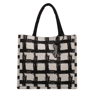 Minimalist canvas tote bag with black brushstroke pattern and bear charm on white background