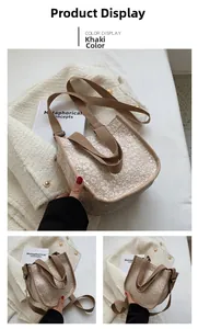 Detail of khaki canvas crossbody bag featuring delicate white floral patterns and strap