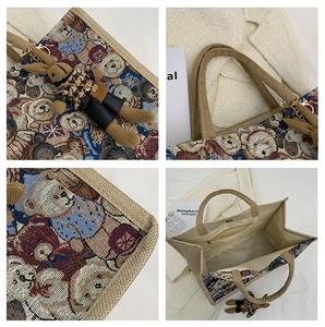 Detail view of linen tote bag with cartoon bear jacquard and plush rabbit pendant charm