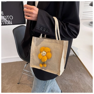Linen lunch bag with sunflower detail and white rope handles in minimalist style