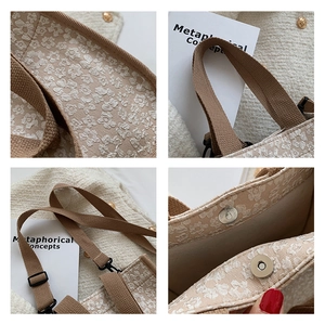 Detail of floral jacquard tote with wide brown strap and silver magnetic closure