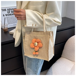Detail of linen tote bag with orange 3D flower and cotton rope handles for women