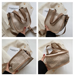Detail view of beige floral canvas tote with brown straps and textured jacquard finish