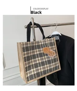 Detail of a black and white checkered tweed tote bag featuring soft brown fur charms