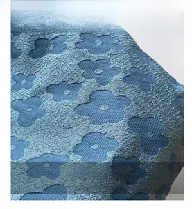 Close-up of light blue floral jacquard fabric with detailed relief texture for tote bag