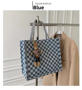 Blue checkerboard canvas tote bag featuring a cute rabbit doll charm on a metal hanger