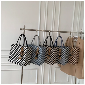 Close-up of checkerboard canvas tote bags in various colors with cute rabbit charms