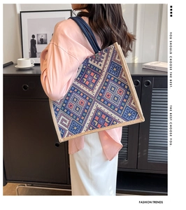Detailed texture of geometric woven pattern on large capacity ethnic tote bag for women