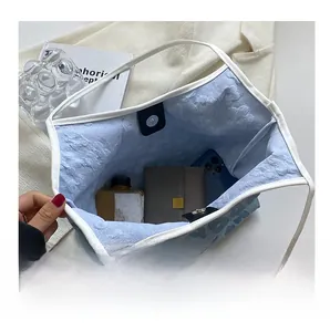 Interior view of floral canvas tote bag showing storage for wallet, phone, and bottle