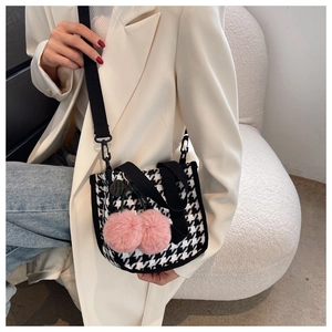 Détail du sac seau en pied-de-poule avec charms cerises roses et bandoulière en toile